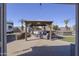 Private backyard oasis featuring a covered patio with seating, a hot tub, and RV parking space at 31918 N Caspian Way, San Tan Valley, AZ 85143