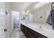 Bathroom featuring a double sink vanity with dark wood cabinetry, large mirror, and a separate toilet and shower room at 31918 N Caspian Way, San Tan Valley, AZ 85143