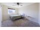 Minimalist bedroom with a twin-size bed, simple furnishings, a ceiling fan, and a bright window at 31918 N Caspian Way, San Tan Valley, AZ 85143