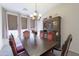 Dining room with wood floors, a dark-wood hutch, and a wood dining table set for six guests at 31918 N Caspian Way, San Tan Valley, AZ 85143