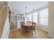 Dining room with wood floors, a farmhouse-style hutch, and a wood dining table set for six guests at 31918 N Caspian Way, San Tan Valley, AZ 85143