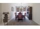 Formal dining room featuring a classic dining table with red upholstered chairs, a decorative chandelier, and display cabinet at 31918 N Caspian Way, San Tan Valley, AZ 85143