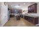 Spacious kitchen with dark wood cabinetry, stainless steel appliances, and an island at 31918 N Caspian Way, San Tan Valley, AZ 85143