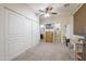 This is the primary bedroom featuring carpet floors, a ceiling fan, and a walk-in shower at 31918 N Caspian Way, San Tan Valley, AZ 85143