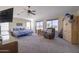 Spacious carpeted main bedroom with a ceiling fan, furniture, and a view of the backyard at 31918 N Caspian Way, San Tan Valley, AZ 85143