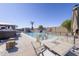Inviting pool area with a waterfall feature, hot tub, surrounding patio, and an outdoor table setting at 31918 N Caspian Way, San Tan Valley, AZ 85143