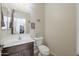 A cozy powder room featuring a vanity and toilet with decorative wall art at 31918 N Caspian Way, San Tan Valley, AZ 85143