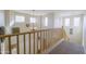 Second story stairway showcasing an open floor plan, abundant natural light, and a charming chandelier fixture at 31918 N Caspian Way, San Tan Valley, AZ 85143
