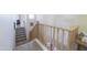 Bright stairway featuring carpeted steps and light wood railing leading to the upper level of the house at 31918 N Caspian Way, San Tan Valley, AZ 85143