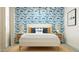Bright bedroom with playful 'RAWR' pillow, complemented by patterned blue wallpaper and warm, inviting lighting at 32679 N Jasper St, San Tan Valley, AZ 85143