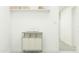 Clean laundry room with white walls, storage shelf, clothes sorting cart, and organized towels at 32679 N Jasper St, San Tan Valley, AZ 85143