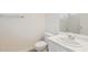 Bright bathroom featuring white fixtures, including a single sink vanity, toilet, and shower over tub at 3321 N Silverado --, Mesa, AZ 85215