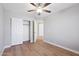 Bedroom featuring wood-look flooring, a ceiling fan, and a closet with sliding doors at 3321 N Silverado --, Mesa, AZ 85215