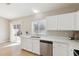 Stylish kitchen with stainless appliances, white cabinets, and a view of the backyard at 3321 N Silverado --, Mesa, AZ 85215