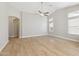 Spacious living room features light, modern wood-look flooring and high vaulted ceiling with ceiling fan at 3321 N Silverado --, Mesa, AZ 85215
