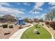 Community playground with modern equipment, lush landscaping, seating and shaded areas at 3321 N Silverado --, Mesa, AZ 85215