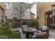 Relaxing backyard seating around a fire pit with lush, mature landscaping at 3911 E Rockingham Rd, Phoenix, AZ 85050