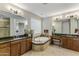 Elegant bathroom featuring double sinks, granite countertops, and a soaking tub at 3911 E Rockingham Rd, Phoenix, AZ 85050