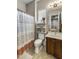 Well-lit bathroom with a floral shower curtain and wood vanity at 3911 E Rockingham Rd, Phoenix, AZ 85050