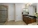 Bathroom showcasing a vanity with granite countertop, and a glass-enclosed shower at 3911 E Rockingham Rd, Phoenix, AZ 85050