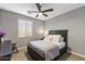 Comfortable bedroom featuring a ceiling fan and window with blinds at 3911 E Rockingham Rd, Phoenix, AZ 85050