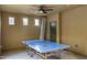 Well-lit bonus room with ceiling fan and a full-size ping pong table at 3911 E Rockingham Rd, Phoenix, AZ 85050
