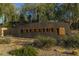Welcoming entrance sign to the Del Webb Fireside community amidst desert landscaping and mature trees at 3911 E Rockingham Rd, Phoenix, AZ 85050