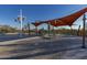 Inviting community pool with lounge chairs, umbrellas and shade structures with beautiful desert landscaping at 3911 E Rockingham Rd, Phoenix, AZ 85050