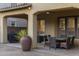 Covered patio with stone columns, fan, outdoor dining set, and BBQ, perfect for entertaining at 3911 E Rockingham Rd, Phoenix, AZ 85050