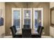 Dining room featuring plantation shutters, an elegant chandelier, and seating for six at 3911 E Rockingham Rd, Phoenix, AZ 85050
