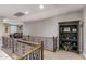 Second-floor hallway with iron railing and a decorative bookcase at 3911 E Rockingham Rd, Phoenix, AZ 85050