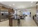 Open kitchen with a breakfast bar connecting to a dining area and a cozy living room at 3911 E Rockingham Rd, Phoenix, AZ 85050