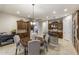 Spacious kitchen with a dining table, wooden cabinets, stainless steel appliances, and modern lighting at 3911 E Rockingham Rd, Phoenix, AZ 85050