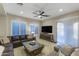 Comfortable living room with a large sectional sofa, a glass coffee table, and bright natural light at 3911 E Rockingham Rd, Phoenix, AZ 85050