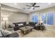 Living room area with a comfortable sectional sofa, stylish coffee table, and ample natural light at 3911 E Rockingham Rd, Phoenix, AZ 85050