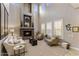 Bright and spacious living room featuring a stone fireplace and large windows at 3911 E Rockingham Rd, Phoenix, AZ 85050