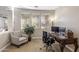 Bright office space with multiple windows, desk, and comfortable chair at 3911 E Rockingham Rd, Phoenix, AZ 85050