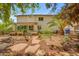 Spacious backyard with a rock garden, patio area, mature trees, and a lush green lawn at 3932 W Rene Dr, Chandler, AZ 85226