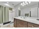 Cozy bathroom with a shower and tub combination, a sleek white sink and dark wood cabinets at 3932 W Rene Dr, Chandler, AZ 85226