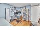 Bedroom featuring hardwood floors, light blue walls, and a functional workspace with dual monitors at 3932 W Rene Dr, Chandler, AZ 85226