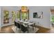 Dining room with stylish lighting, seating for six, and natural light from the French doors at 3932 W Rene Dr, Chandler, AZ 85226