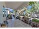 Charming covered patio with tile flooring surrounded by lush greenery and desert landscaping at 3932 W Rene Dr, Chandler, AZ 85226