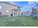 Spacious backyard features a covered patio, lush green grass, storage sheds, and a trampoline for outdoor enjoyment at 40613 N Jerlyn Pl, San Tan Valley, AZ 85140