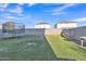 This backyard features grass, a trampoline, and a block wall fence at 40613 N Jerlyn Pl, San Tan Valley, AZ 85140