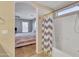 View from bathroom to bedroom with a shower/tub combo at 40613 N Jerlyn Pl, San Tan Valley, AZ 85140