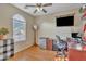 Bedroom features a ceiling fan, mini-fridge, large window, and desk area at 40613 N Jerlyn Pl, San Tan Valley, AZ 85140