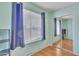 This bedroom has wood floors, a mirrored closet, a window, and a ceiling fan at 40613 N Jerlyn Pl, San Tan Valley, AZ 85140