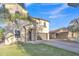 Lovely two-story home showcasing a stucco exterior, arched entry, and lush green lawn at 40613 N Jerlyn Pl, San Tan Valley, AZ 85140
