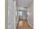 Hallway with wood-look floors and doorways to closets, bedrooms, and bathrooms at 40613 N Jerlyn Pl, San Tan Valley, AZ 85140
