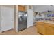 A modern refrigerator stands near a staircase, enhancing the home's utility and aesthetic appeal at 40613 N Jerlyn Pl, San Tan Valley, AZ 85140
